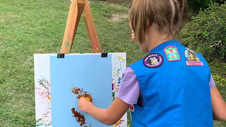 Scout painting with marigold