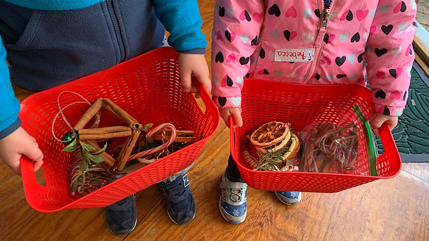 children holding baskets of crafts