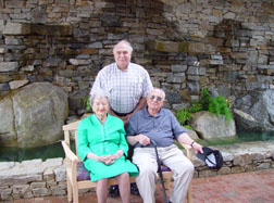 Charles (Chuck) Manooch, III, Ph.D., (standing); Annie Laurie Williams (left); and Charles Manooch, Jr. (right).