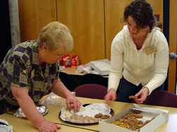 Linda Glenn (left) and Anna Absher (right) arrange cookies for the guests that attended Roy Dick’s readings.
