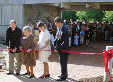 James Oblinger, Ruby McSwain, Marye Anne Fox, and Bob Lyons cut the ribbon at the Ruby C. McSwain Education Center's dedication ceremony on September 21, 2002